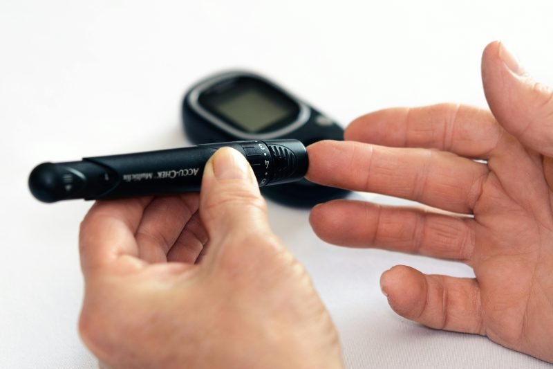 a person using a lancet to check the blood sugar level