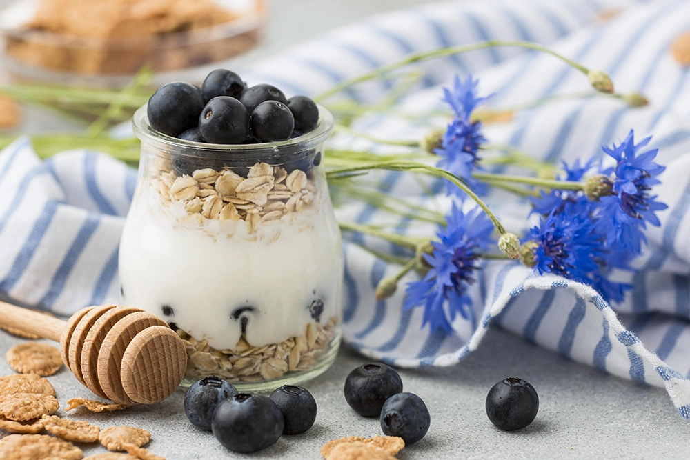 a jar of oatmeal with blueberries and yogurt