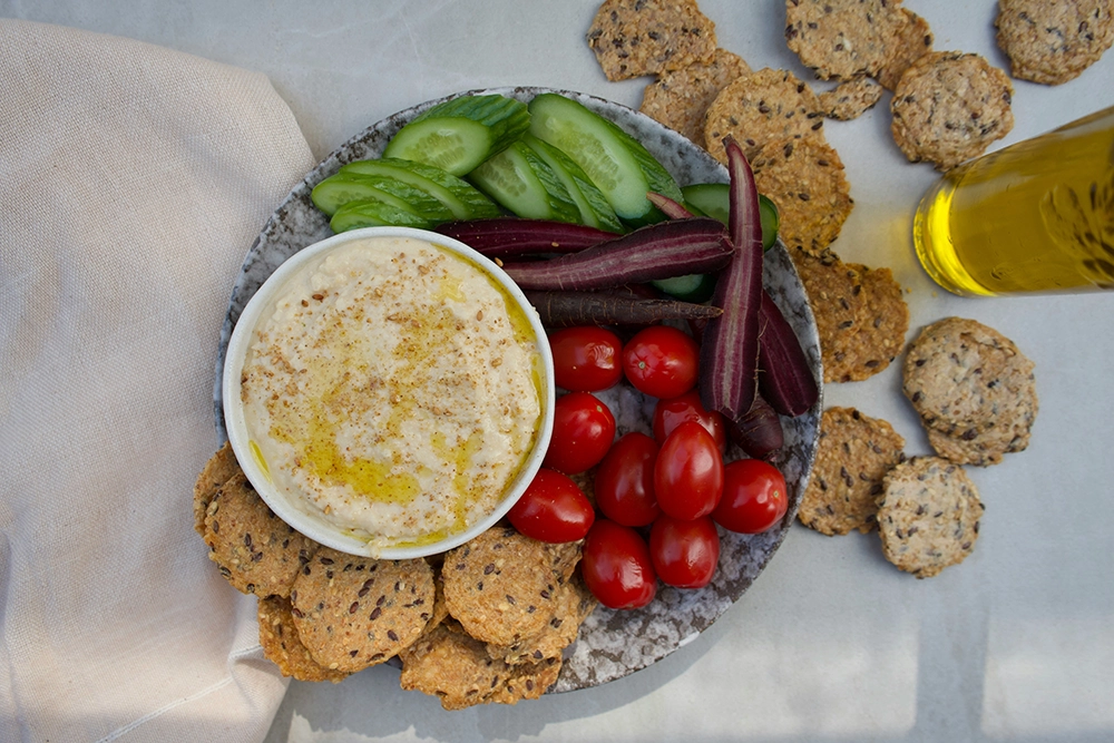 a plate of food with crackers and vegetables