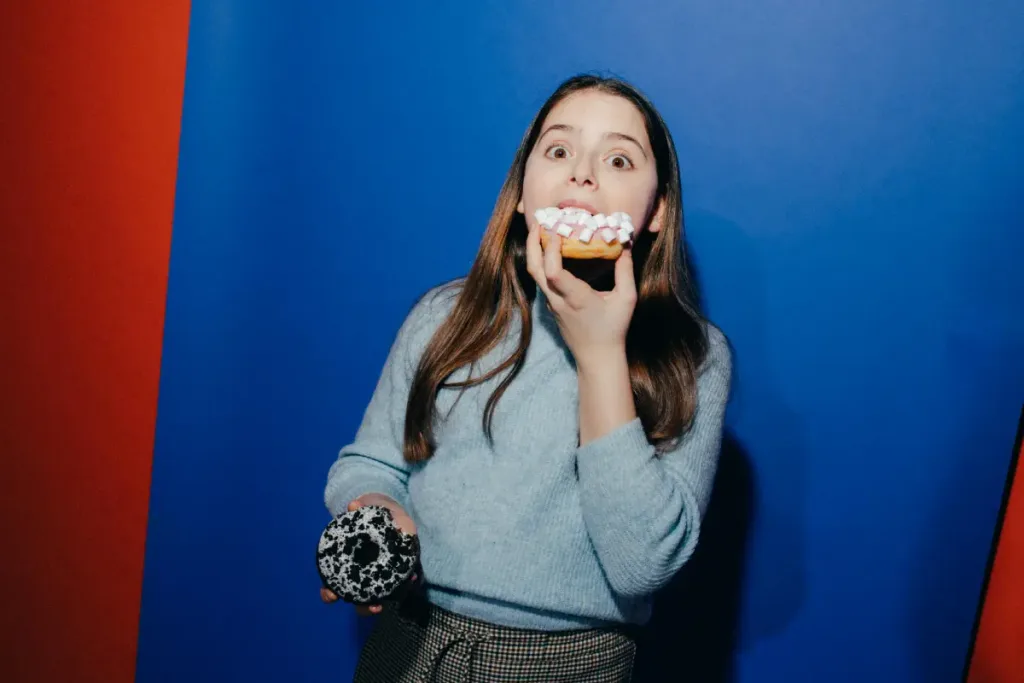 a girl eating a donut