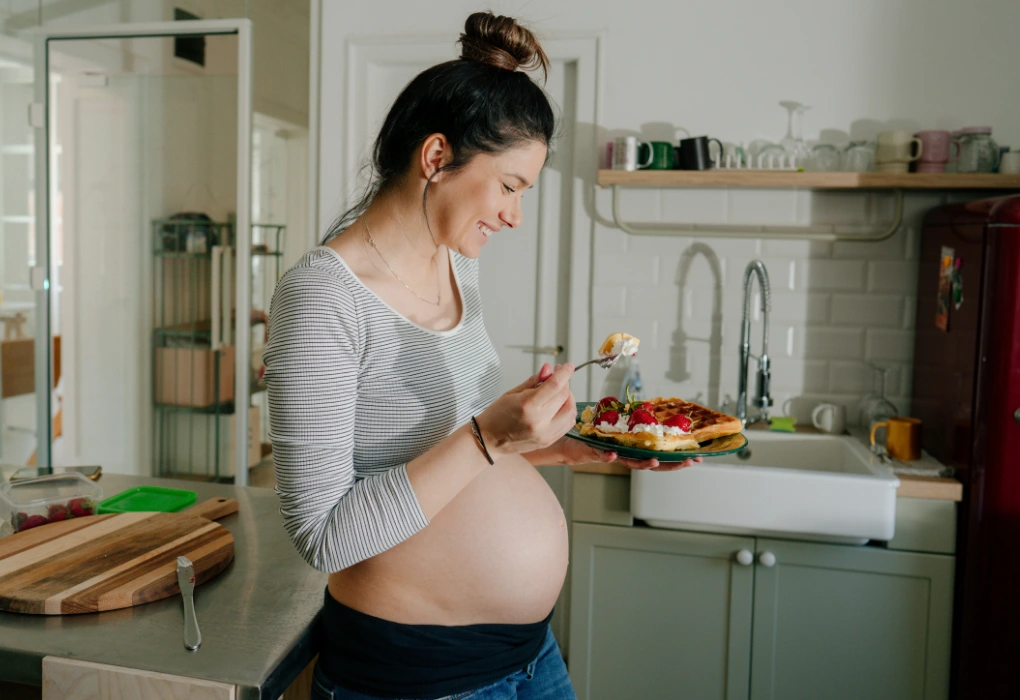 pregnant woman eating sweets