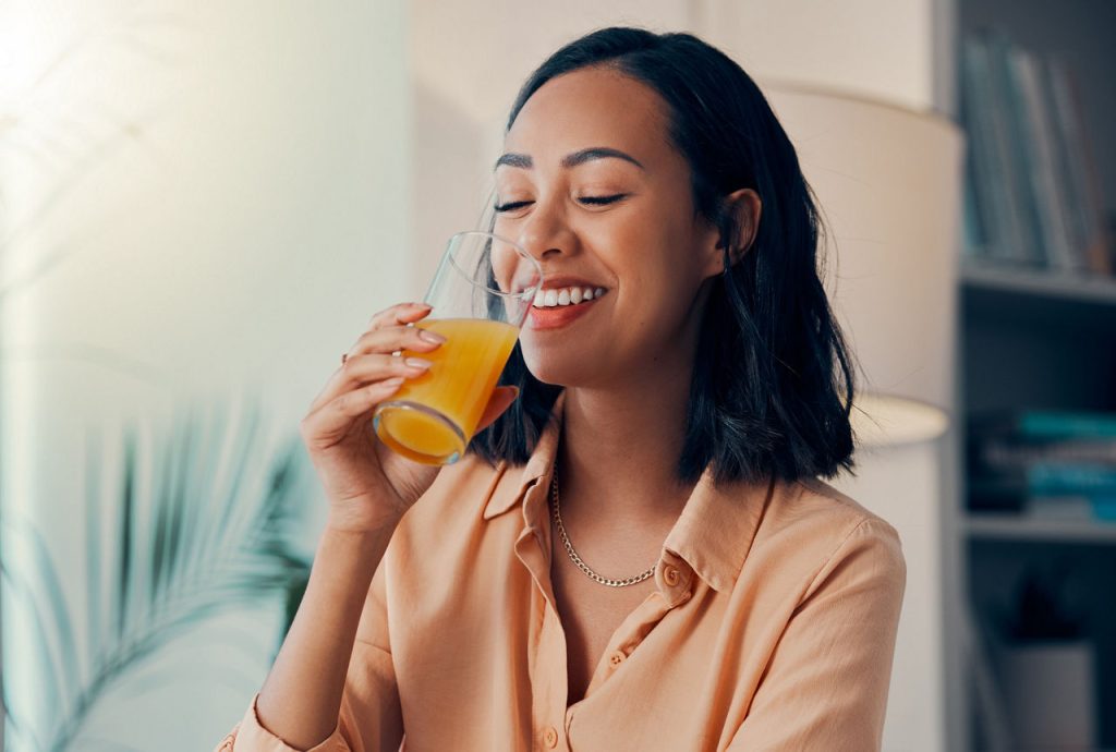 woman drinking orange juice